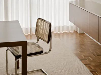 Modern home office featuring a sleek, dark wood desk and minimalist chair