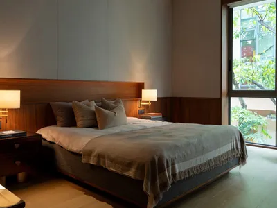 A modern bedroom with a Scandinavian slate wall and wooden furniture.