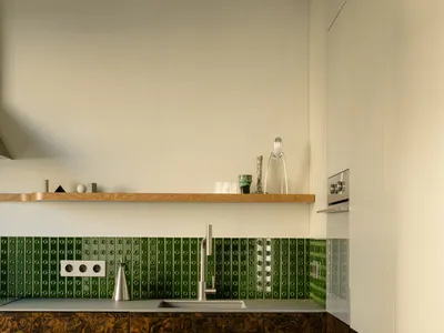 Modern kitchen featuring marble countertops and backsplash