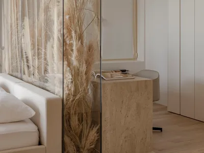 A modern minimalist bedroom featuring a wooden bed frame, glass closet doors, and fabric curtains with pampas grass plant.