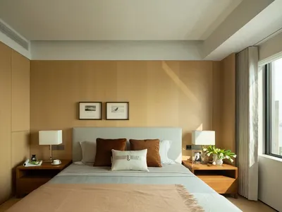 A minimalist bedroom with a bed, nightstands, and framed pictures on the wall.