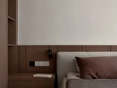 A minimalist bedroom featuring a wooden bed frame and headboard, with a simple and clean design.