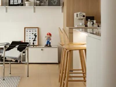 A minimalist home office featuring wooden shelves and modern furniture.