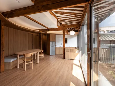 Modern kitchen featuring minimalist design with wood accents and glass paneling.