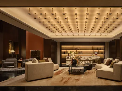 Modern luxury hotel lobby with marble countertops, concrete accents, and luxurious seating arrangements.