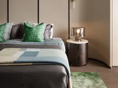 A minimalist bedroom with a bed, green pillows, and a side table with a lamp.