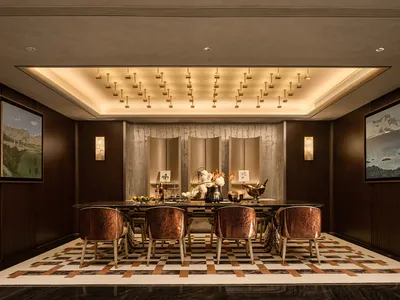 Modern restaurant interior featuring marble finishes and wooden elements.