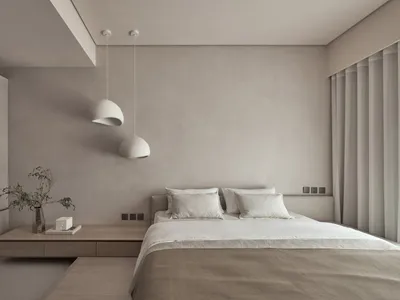 A minimalist bedroom with neutral tones and white pendant lights.