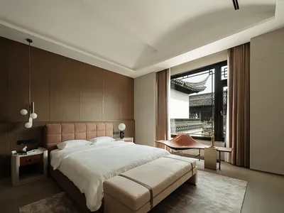 A minimalist bedroom with a wooden headboard, white bedding, and modern lighting.