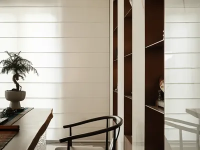 A modern home office space featuring wooden furniture and decorative elements.