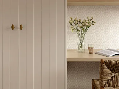 A minimalist home office space featuring wooden furniture and textiles.