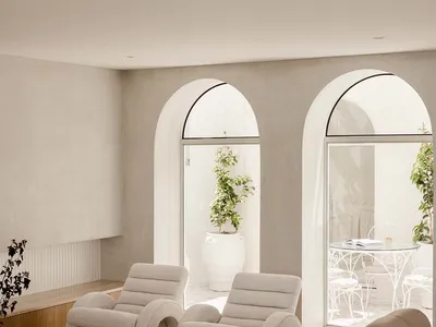 A minimalist living room featuring beige fabric furniture and a modern design.