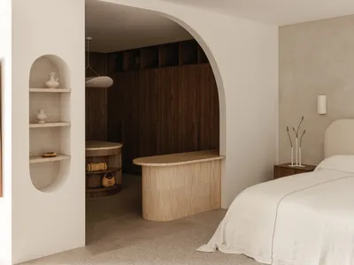 Minimalist bedroom with a large bed, wooden headboard, and built-in shelves.