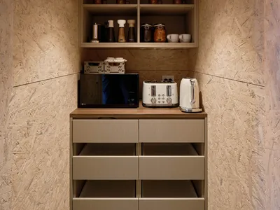 A modern kitchen with wooden cabinets, cupboards, and drawers.