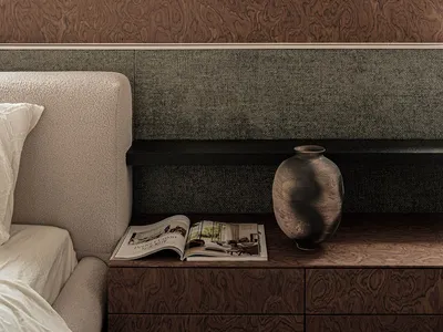 Modern minimalist bedroom features a wood-textured wall and nightstand with a vase and open magazine.