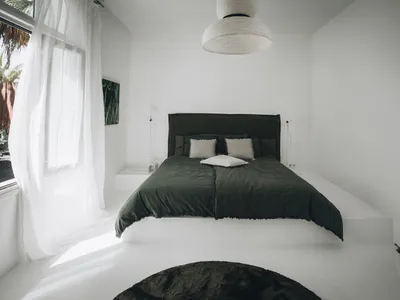Modern minimalist bedroom with neutral colors and cotton blend bedding.