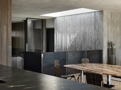 Industrial restaurant interior with concrete walls and marble table