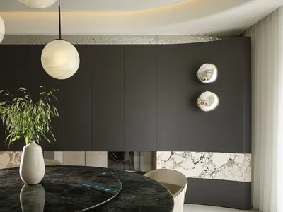 A modern kitchen with marble countertops and cabinets.