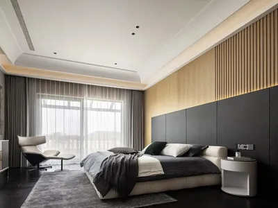 Minimalist bedroom with wooden walls, glass sliding doors, and a leather bed.