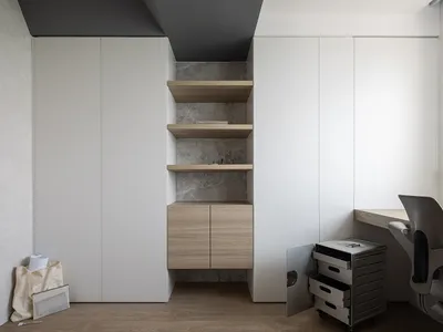 Minimalist home office featuring modern storage solutions with wood, concrete, and metal elements.