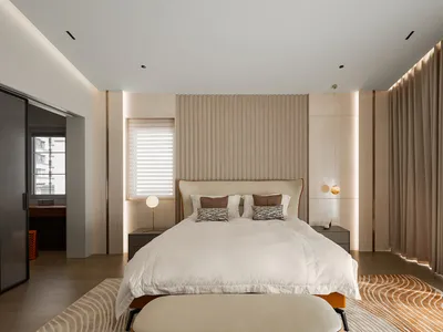 Modern minimalist bedroom with a wooden headboard and wall。