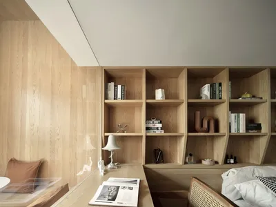 Modern bedroom with wooden walls, slanted ceiling, and single bed