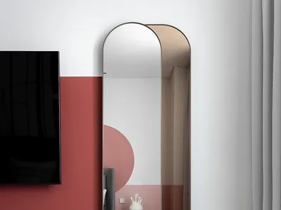 A modern bedroom featuring a glass mirror and a sleek, contemporary design.