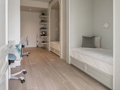 A minimalist bedroom featuring wooden furniture and painted walls.