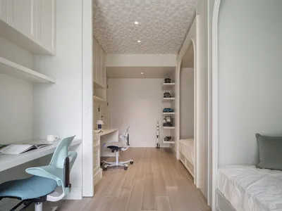 A modern minimalist bedroom with wood flooring and furniture.
