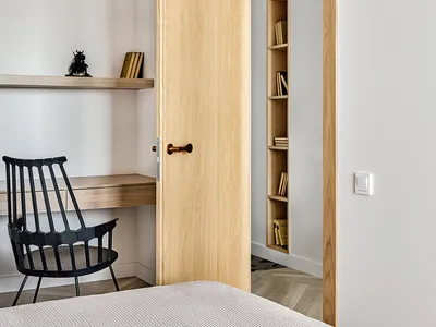 Modern minimalist bedroom with wooden furniture and open shelving.