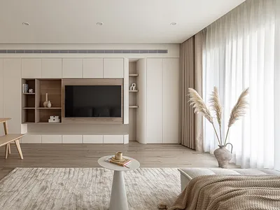 A minimalist living room featuring a wall-mounted television, wooden furniture, and beige accents.