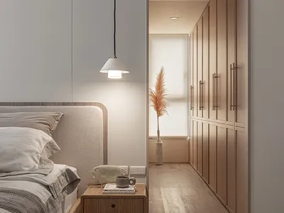 A minimalist bedroom featuring a wooden bed and glass wardrobe with textile bedding and a pendant light fixture.