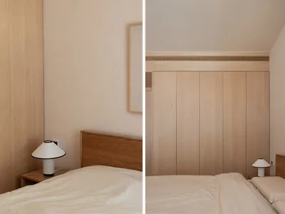 Bedroom with minimalist design, featuring wooden furniture and fabric bedding.