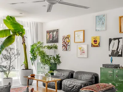 A living room with industrial design elements, featuring leather sofas, metal accents, and wooden coffee table.