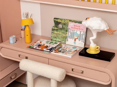 A modern casual home office with pink furniture and decorative elements.