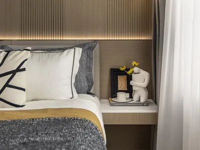 Modern minimalist bedroom with wooden texture, featuring a bed with white and gray pillows and a white nightstand with a scul
