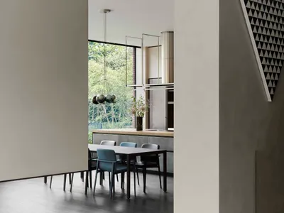 Modern minimalist kitchen with concrete flooring and dining area.