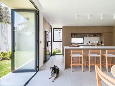A modern kitchen featuring wooden cabinets and a white countertop.
