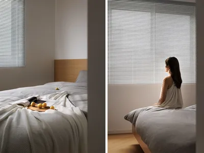 A minimalist bedroom featuring window blinds.
