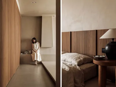 A serene minimalist bedroom with wooden walls and a cozy ambiance.