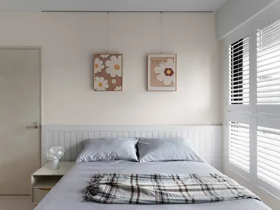 A minimalist bedroom featuring mixed materials and patterns.