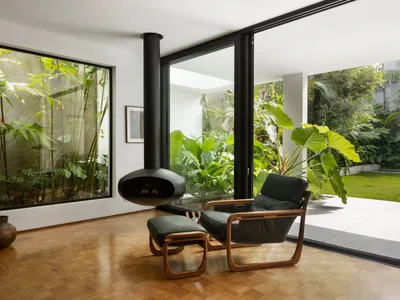 Modern industrial living room with wooden furniture and a fireplace.