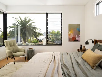 A minimalist bedroom featuring wood, fabric, and metal elements.
