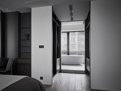 A modern minimalist bedroom with wooden flooring, white walls, and a glass-enclosed bathroom.