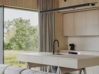 Modern residential kitchen featuring a sleek concrete countertop and minimalist design.