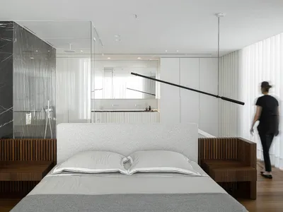 modern minimalist bedroom with white walls, wood headboard, and marble accents