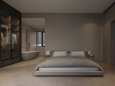 A modern, minimalist bedroom with dark interior design featuring a platform bed, wooden floors, and a glass-walled bathroom w