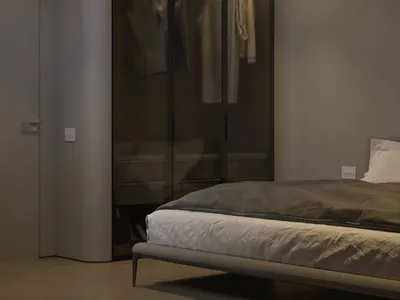 A modern minimalist bedroom with a bed, wardrobe, and natural lighting.