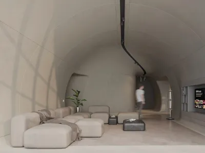 Modern living room with minimalist design, concrete walls, and leather furniture.