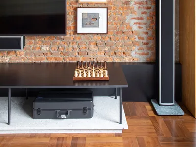 Living room with exposed brick walls, wooden floor, and modern furniture
